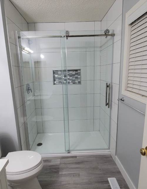 Citadel white bathroom with frameless glass shower