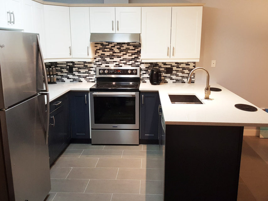 Navy island with white perimeter cabinetry