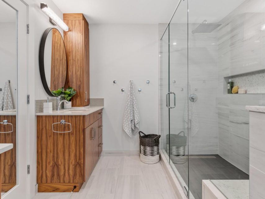 Glass shower beside walnut vanity