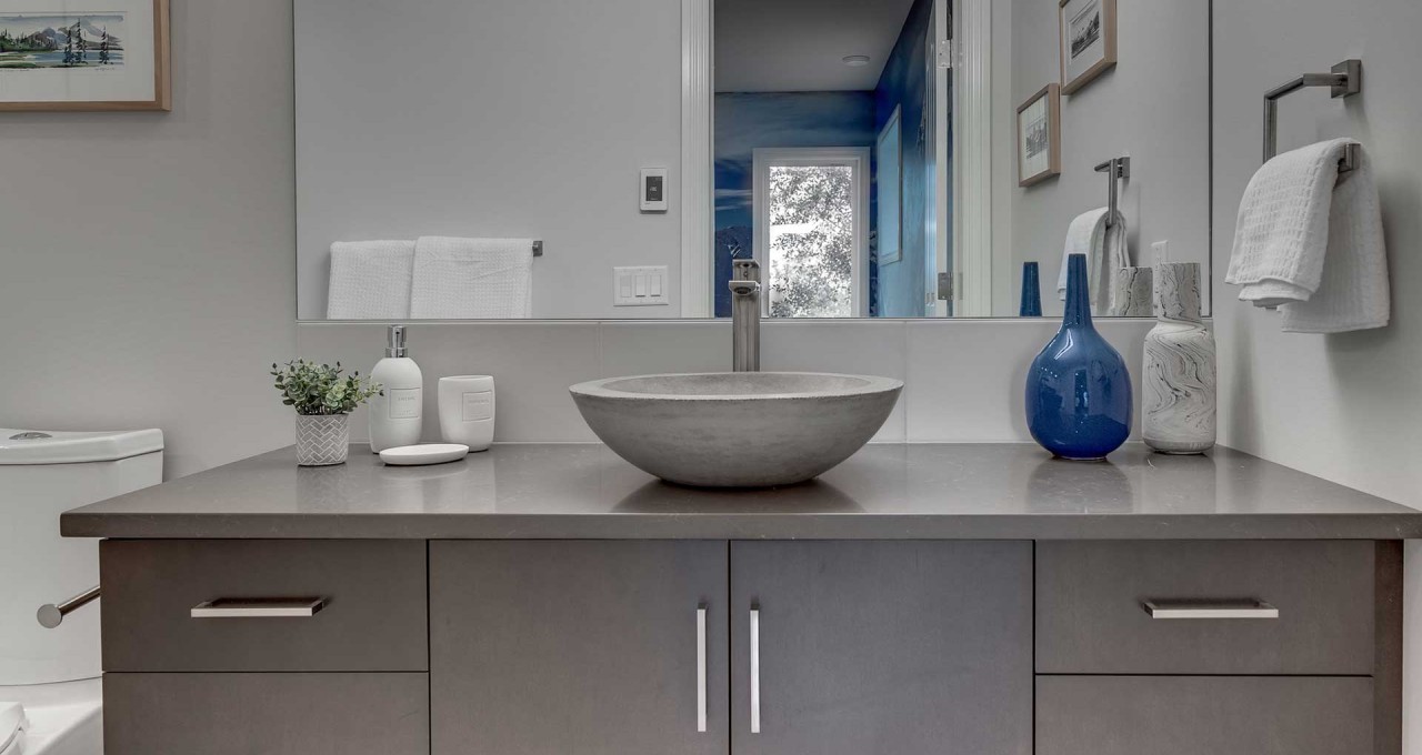 Pink soaking tub against stone tile