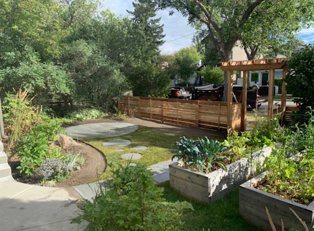 a garden with a gazebo in the middle of it